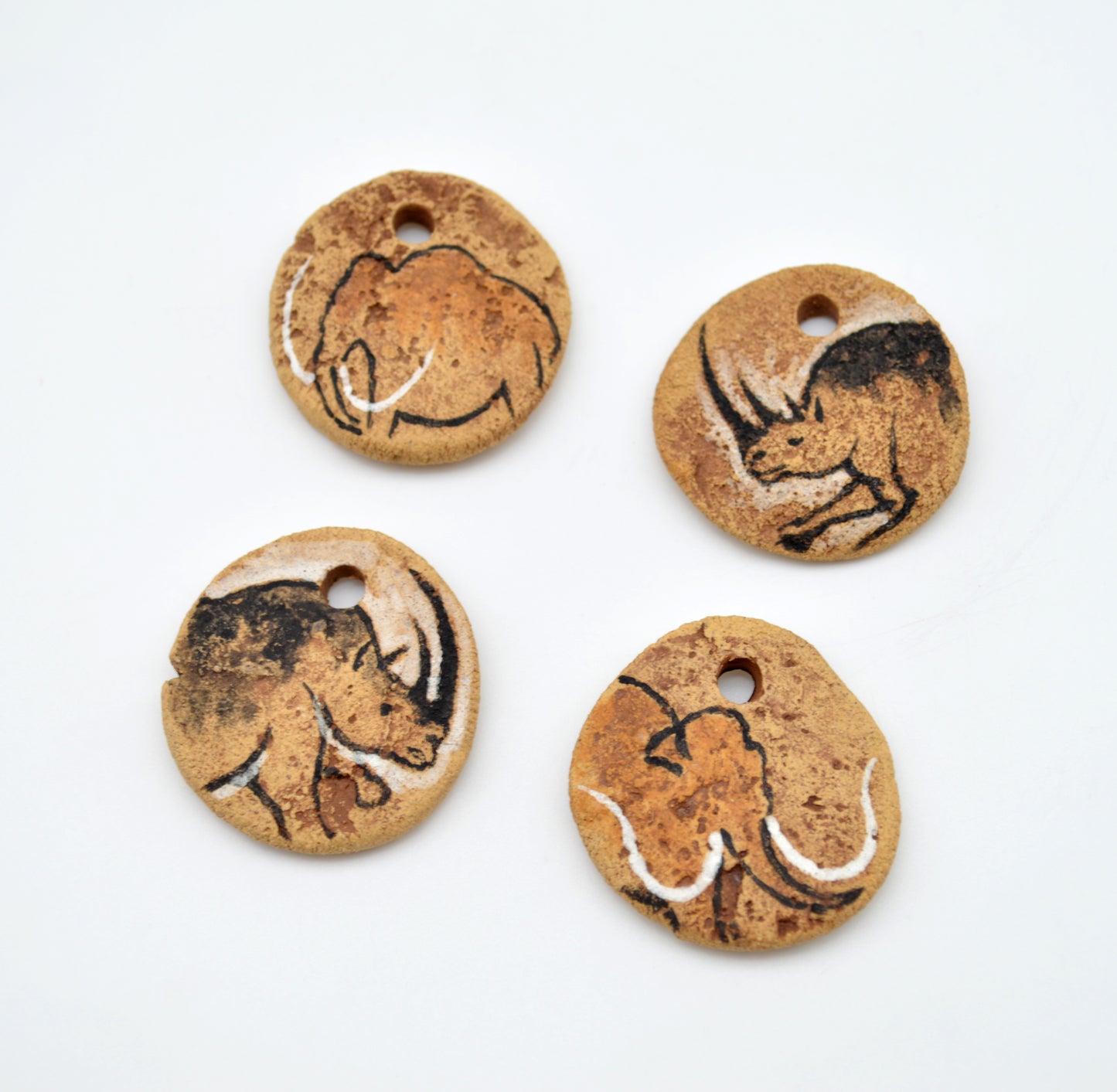 Cave Art Mammoth & Rhino Pendants