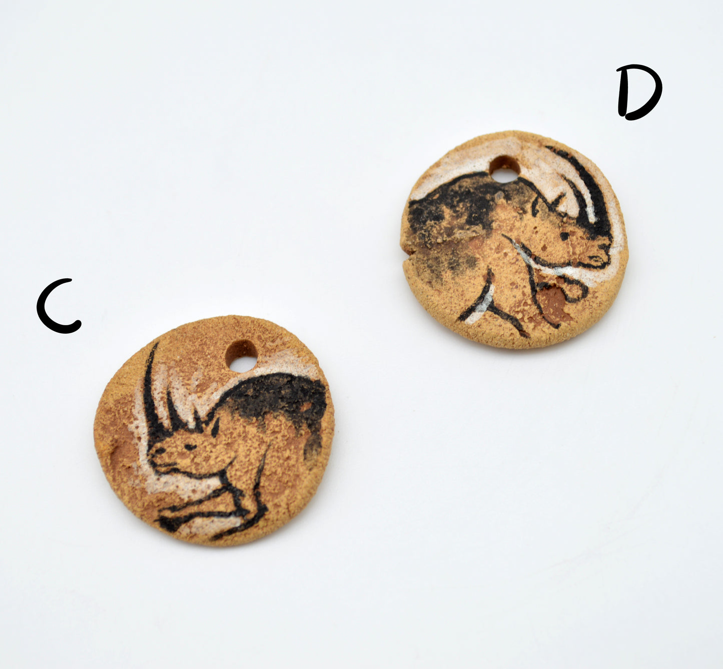 Cave Art Mammoth & Rhino Pendants